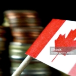 Canada flag waving with stack of money coins macro
