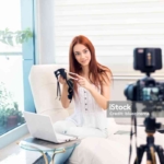 Female vlogger making social media video about fashion shoes for the internet