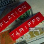 Red Tariffs and Inflation labels on a hundred dollar bill