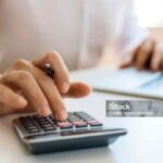 Unrecognizable businessman calculating and planning at office