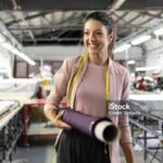 Smiling young woman working in a fashion factory