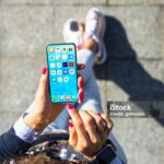 Woman using her mobile phone, home screen mockup with app icons