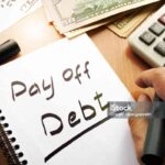 Note with words pay off debt concept.