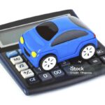 Calculator and toy car isolated on white background