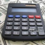 calculator on heap of dollars