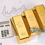 "Photo of gold bars on graphs and statistics, studio shots, closeup"