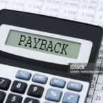 PAYBACK word on Calculator and pen on bank account documents