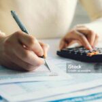Closeup woman filling form of Individual Income Tax Return,