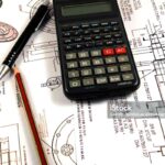 Scientific calculator, Pen and Pencil over the Engineering Drawing Map