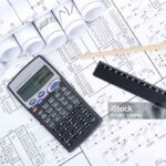 Drawings rolled in a tube, calculator, pencil and ruler