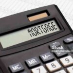 A calculator with the word MORTGAGE on the display