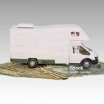 Toy car, money over white. Rent, buy or insurance car