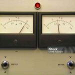 Front of a laboratory power supply showing dual readout panel meters