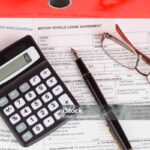 motor vehicle lease agreement with fountain pen and calculator