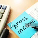 Gross income written on a memo stick.