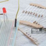 Potentiometer, resistors and red LED set up on a breadboard