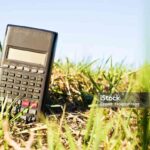 Black Electronic Scientific Calculator On Green Grass