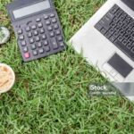 old laptop with office equipment on grass background