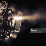 Movie projector on a dark background with light beam / high contrast image