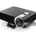 One modern video projector isolated on white