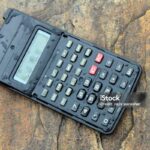 a wet scientific calculator isolated on stone background