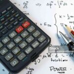 Eye Glasses, pen and pencil over the Formula with calculator