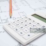 Architectural drawing, calculator and pencil