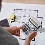 Architect using a calculator to calculate the usable area