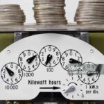 Coins on top of an electricity meter. The cost of Kilowatt hours.