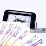 The photo shows an AC electricity counter with euro bills